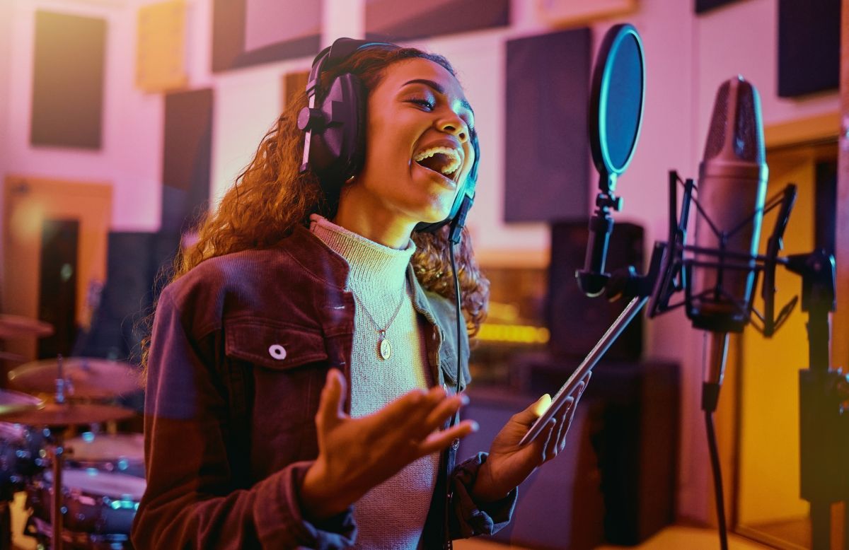 Woman singing in a recording studio